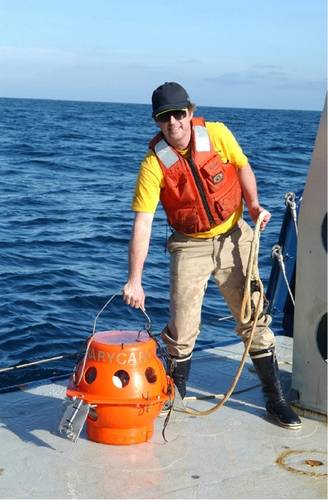 Figure 7. The author, Kevin Hardy, lifts the single sphere hadal lander, DOV Mary Carol, with one hand onto the ship after a test dive off San Diego in 2002. DOV Mary Carol later dove both the Puerto Rico Trench and Aleutian Trench. (Photo by Dr. Art Yayanos, Scripps Institution of Oceanography/UCSD)