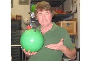 Figure 3.  The author with a 440Wh car battery that floats! (Photo by Brian Hardy, Global Ocean Design)