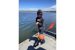 Figure 1.  Sawyer Granados, a fourth grader in San Diego, California, hauls in his STEM Lander after a successful dive to 15-ft in Mission Bay.  His STEM Lander has yet to dive the blue Pacific Ocean. The pre-publication boat trip was scrubbed by high surf.  Something to learn there, too.  (Photo: Kevin Hardy)